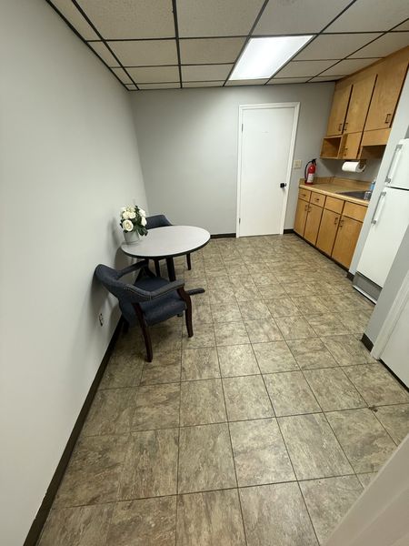 Shared breakroom with table, sink and refrigerator
